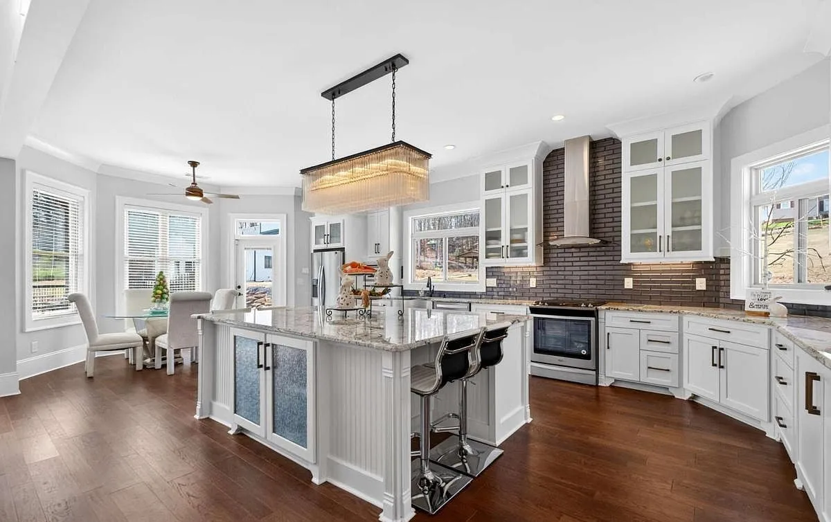 Kitchen with a granite island and painted cabinetry